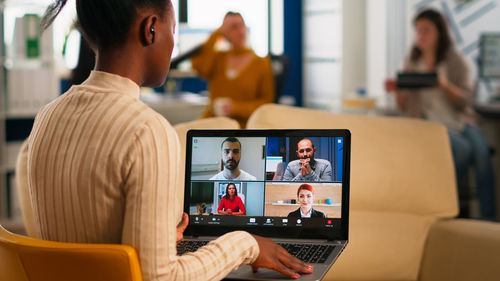 Rear view of businesswoman talking on video conference