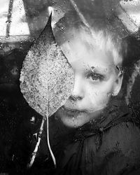 Close-up portrait of wet woman in autumn leaves