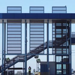 People on staircase in city against sky