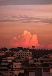 High angle view of townscape against orange sky