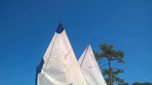 Low angle view of sculpture against blue sky