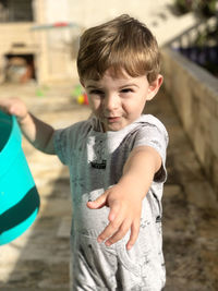 Portrait of cute boy standing outdoors