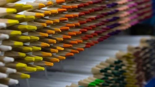 Close-up of multi colored pencils in row