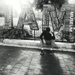 Men sitting on street in city