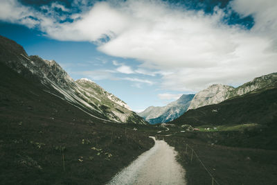 Road amidst mountains against sky