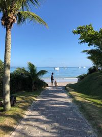 Man standing with dog at beach