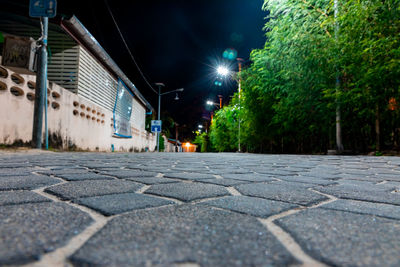 Surface level of street amidst buildings at night