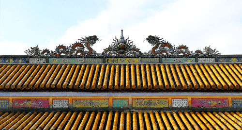 Low angle view of roof and building against sky