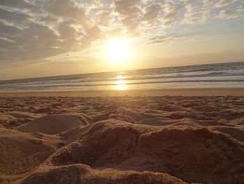 Scenic view of beach against sky during sunset