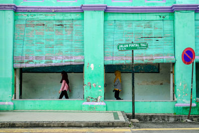 Side view of women walking on sidewalk