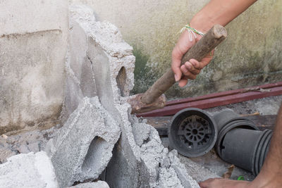 Close-up of man working at shore