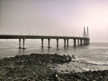 Bridge over sea against sky