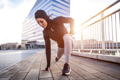 Full length of woman on bridge against sky in city