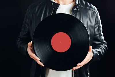 Playing music from vinyl record. vintage and retro. man holding analog record. classic audio. mockup