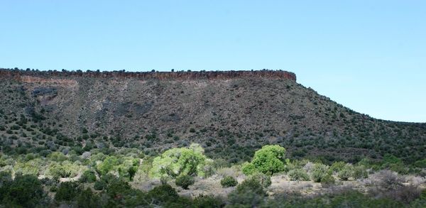 Low angle view of mountain against clear blue sky