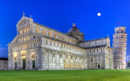 Piazza del duomo o dei miracoli or cathedral square of miracles by night, pisa, italy