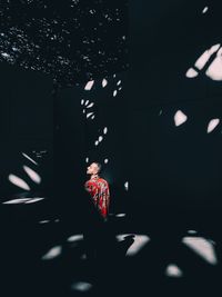 Midsection of man standing in illuminated building