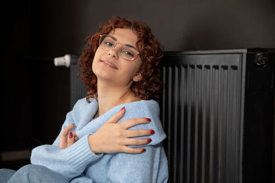 Portrait of smiling young woman looking away at home