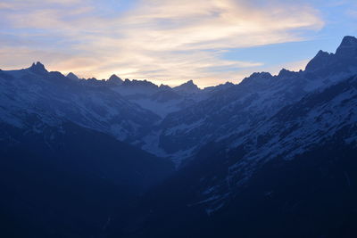 Scenic view of snowcapped mountains against sky