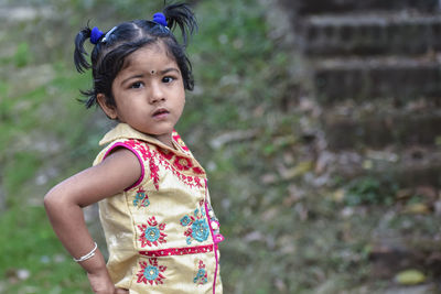 Portrait of cute girl standing outdoors