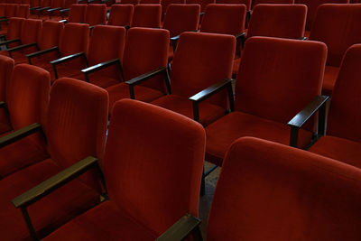 Empty red chairs in row at theater