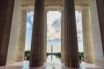 View of historic building seen through colonnade