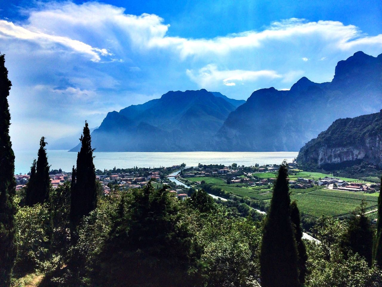 mountain, mountain range, scenics, sky, tranquil scene, beauty in nature, water, tranquility, nature, cloud - sky, sea, landscape, cloud, tree, idyllic, lake, panoramic, outdoors, non-urban scene, day