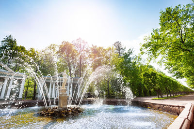 Water fountain in swimming pool against sky