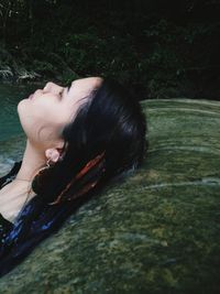 Young woman leaning in stream