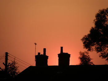 Low angle view of silhouette trees against sky at sunset