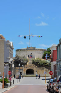 Flags at round house against sky on sunny day