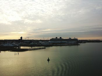 Calm sea with buildings in background