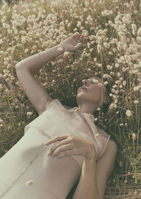 Woman lying among harestail grass 