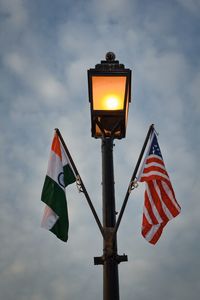 Lamp post silhouette with cloudy sky.