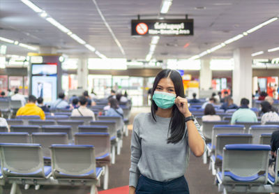 Portrait of woman wearing mask at airport