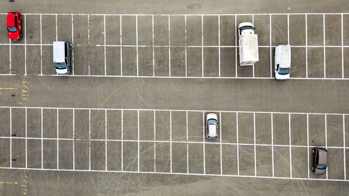 High angle view of people walking on chainlink fence