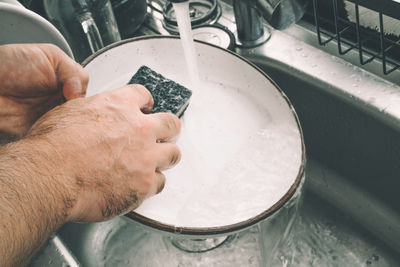 Man washing dishes at home