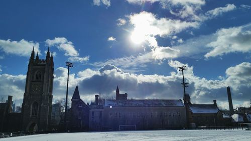 Snow covered university against cloudy sky