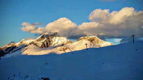 Scenic view of mountains against cloudy sky