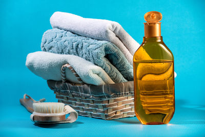 Close-up of bottle on table against blue wall