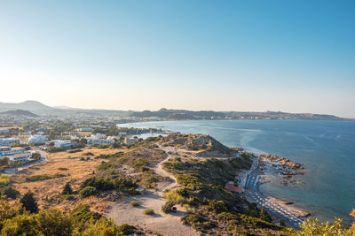 High angle view of townscape by sea against clear sky