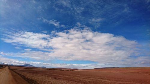 Scenic view of landscape against blue sky