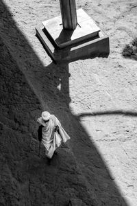 Aerial view of robed holy man walking amongst the rock-hewn churches of lalibela, ethiopia.