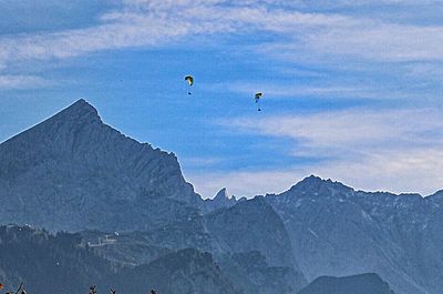 Low angle view of airplane flying over mountains