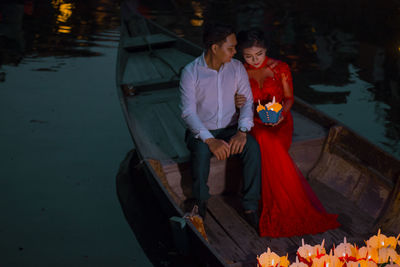 Young man and woman holding umbrella