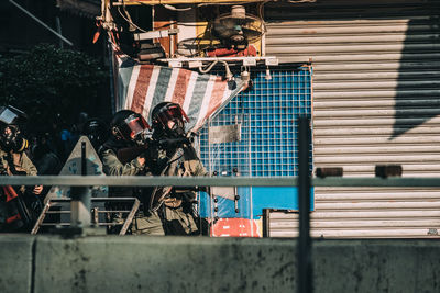 Graffiti on railing by buildings in city