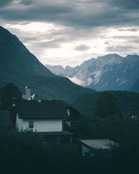 Scenic view of houses and mountains against sky