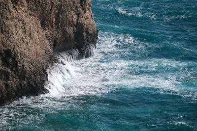 Sea waves splashing on rock