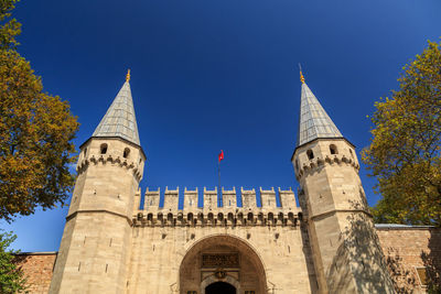 Low angle view of historic building against blue sky