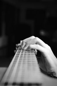 Cropped image of hand holding guitar